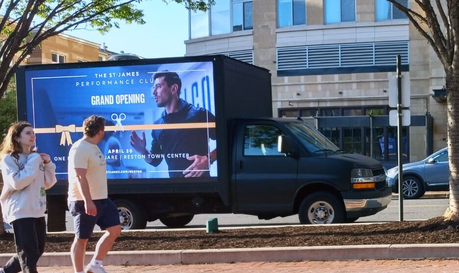 fitness studio and gym advertising to people on the sidewalk using a led billboard truck rental