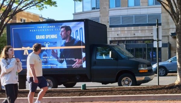 fitness studio and gym advertising to people on the sidewalk using a led billboard truck rental